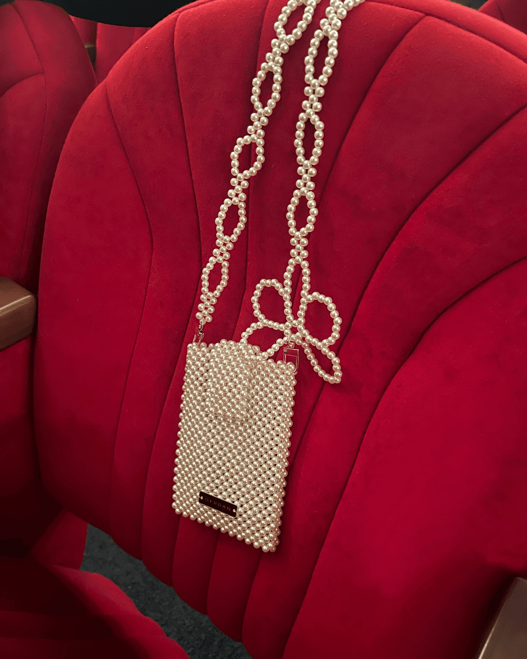 beaded pearl case on velvet chair